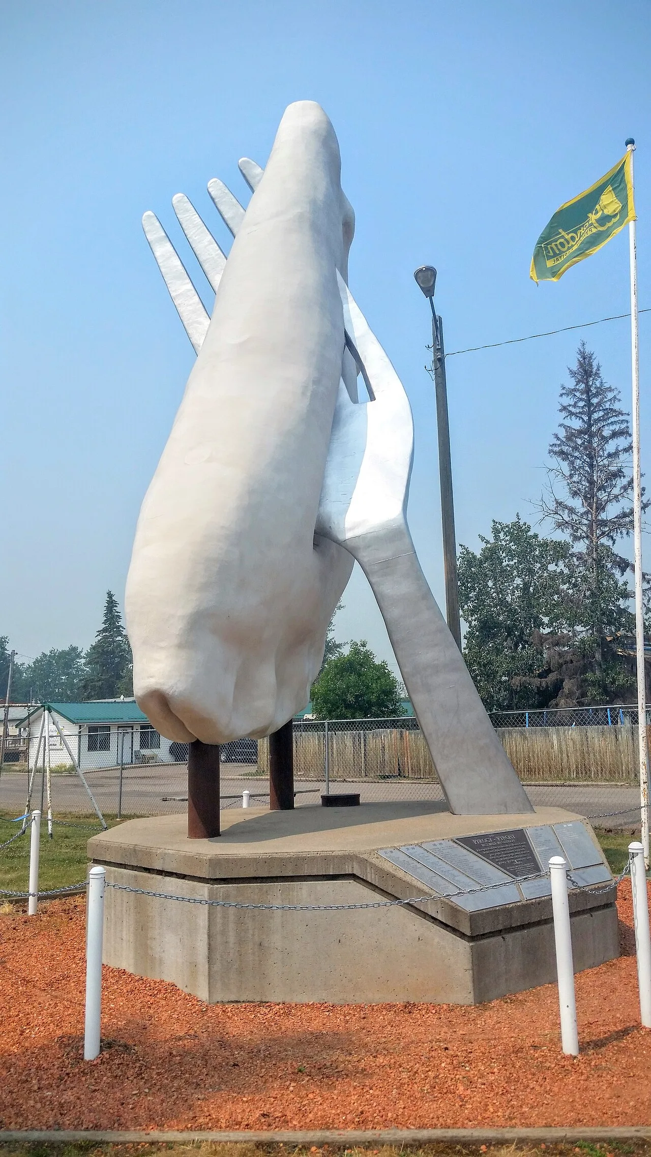 Photograph of the Giant Perogy statue in Glendon, Alberta, a huge perogy speared on a giant fork above a concrete pedestal